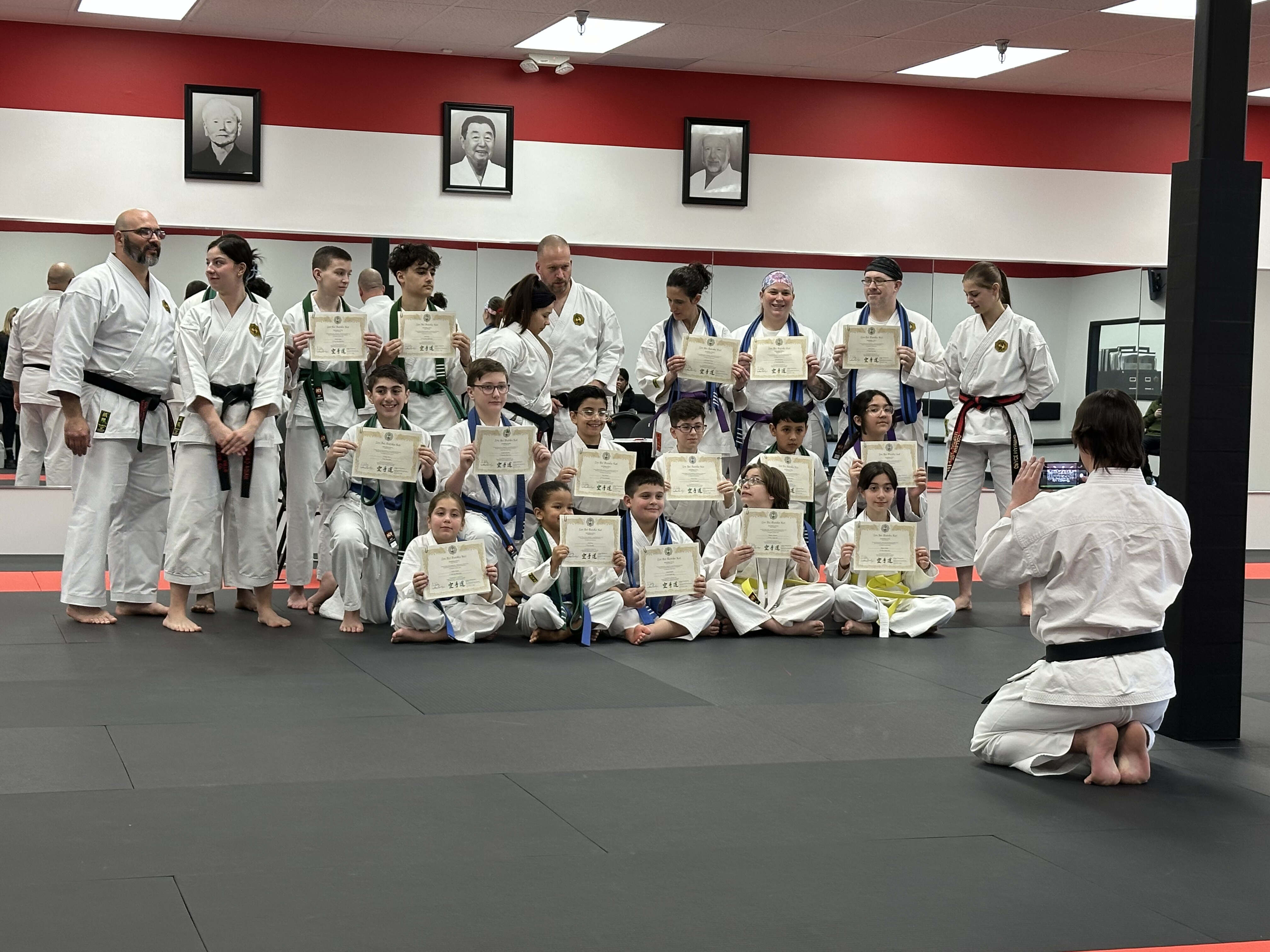 Class posing for a post belt exam photo